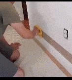 GIF A man is using Martify's EdgeMaster Paint Roller on a wall.