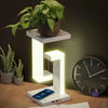 Martify LED night light with wireless charger and dimmable features, adorned with plant and accompanied by phone.